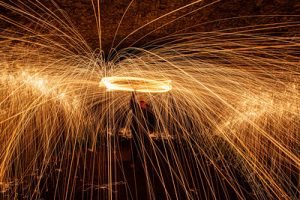 Steel wool fire spinning long exposure photography